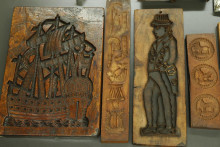 wood carved cookie cutters with human figures and a ship with sails